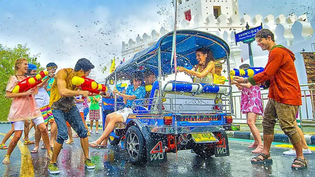 Teenagers playing during Songkran festival around Tuk Tuk in Bangkok, Thailand.